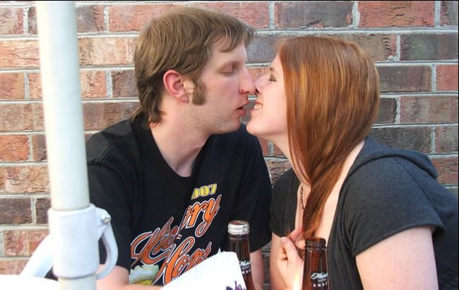 Couple kissing at an outdoor restaurant