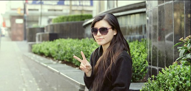 Woman making a peace sign