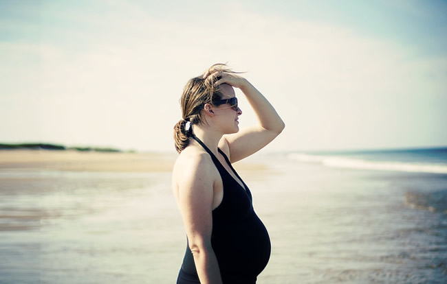 Pregnant woman on the beach.